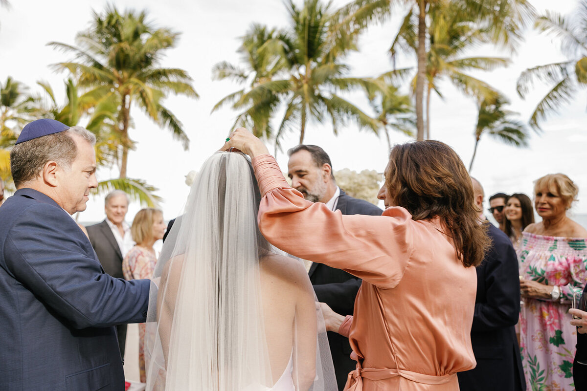 Family members bless the bride before the ceremony in a touching Jewish wedding tradition. Destination wedding photography by Claudia Amalia.