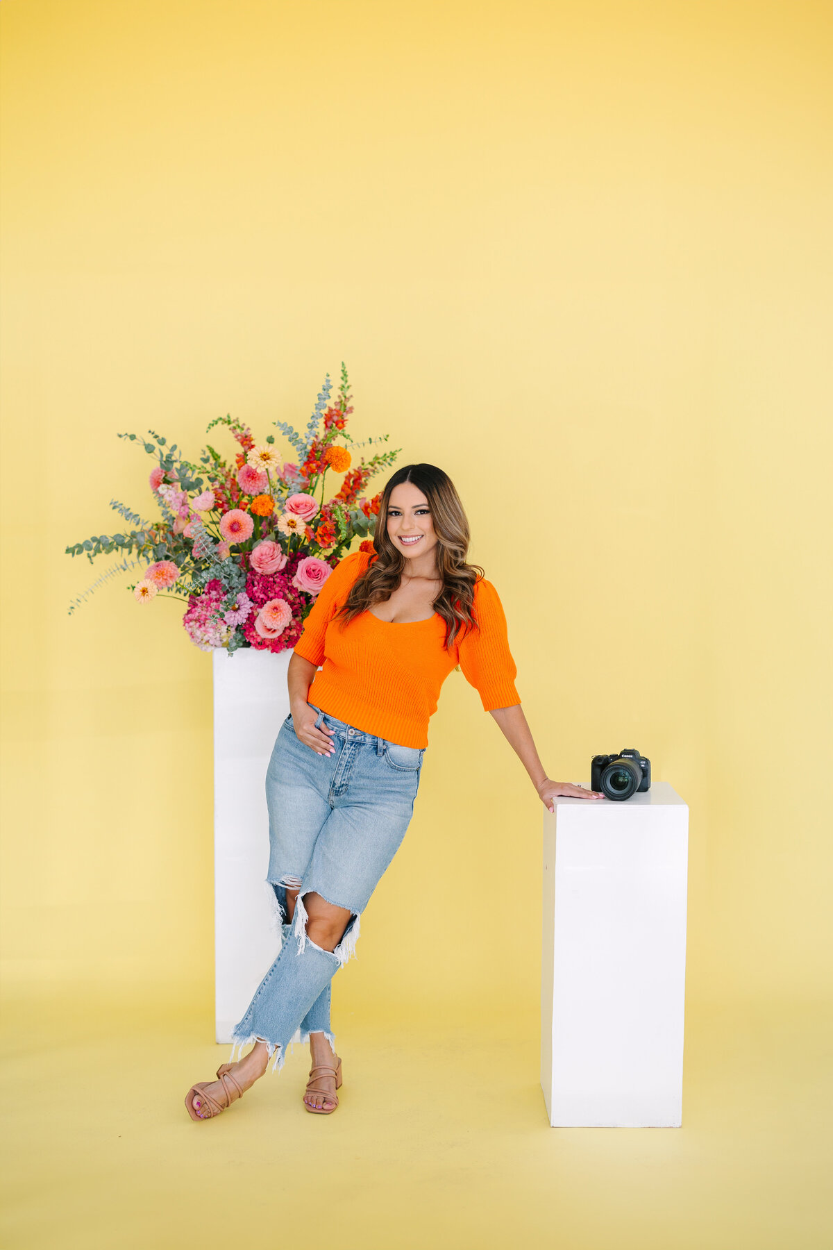 Big Sur wedding photographer posing with floral arrangements