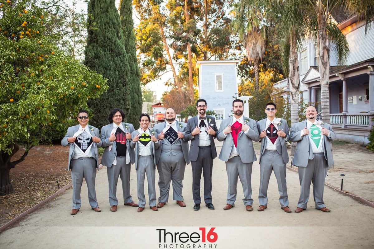 Groom and Groomsmen expose their superhero's when opening their shirts