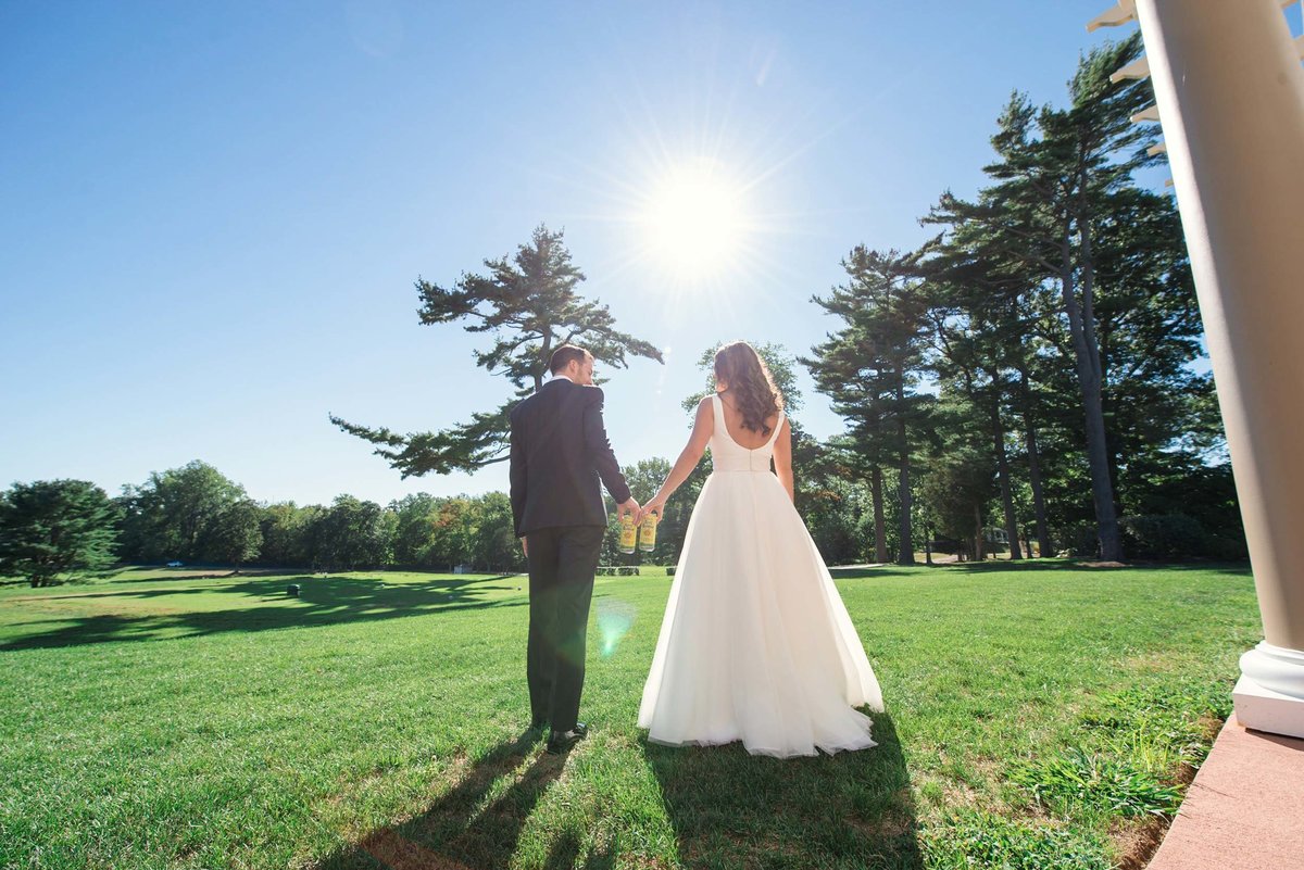 Bride and groom holding hands walking at Stonebridge Country Club