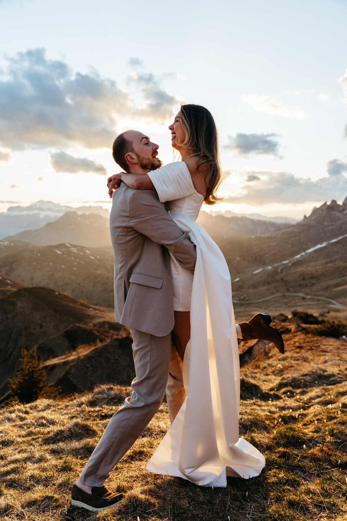 happy couple during sunset in Dolomites