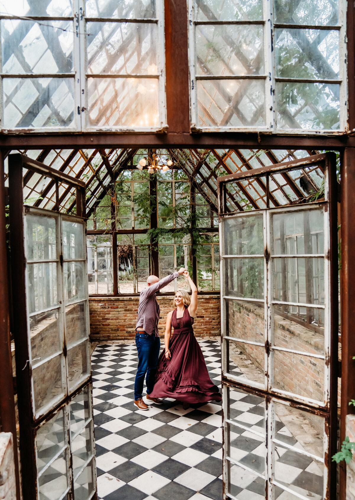 Family Photographer, a husband and wife dance in a green house