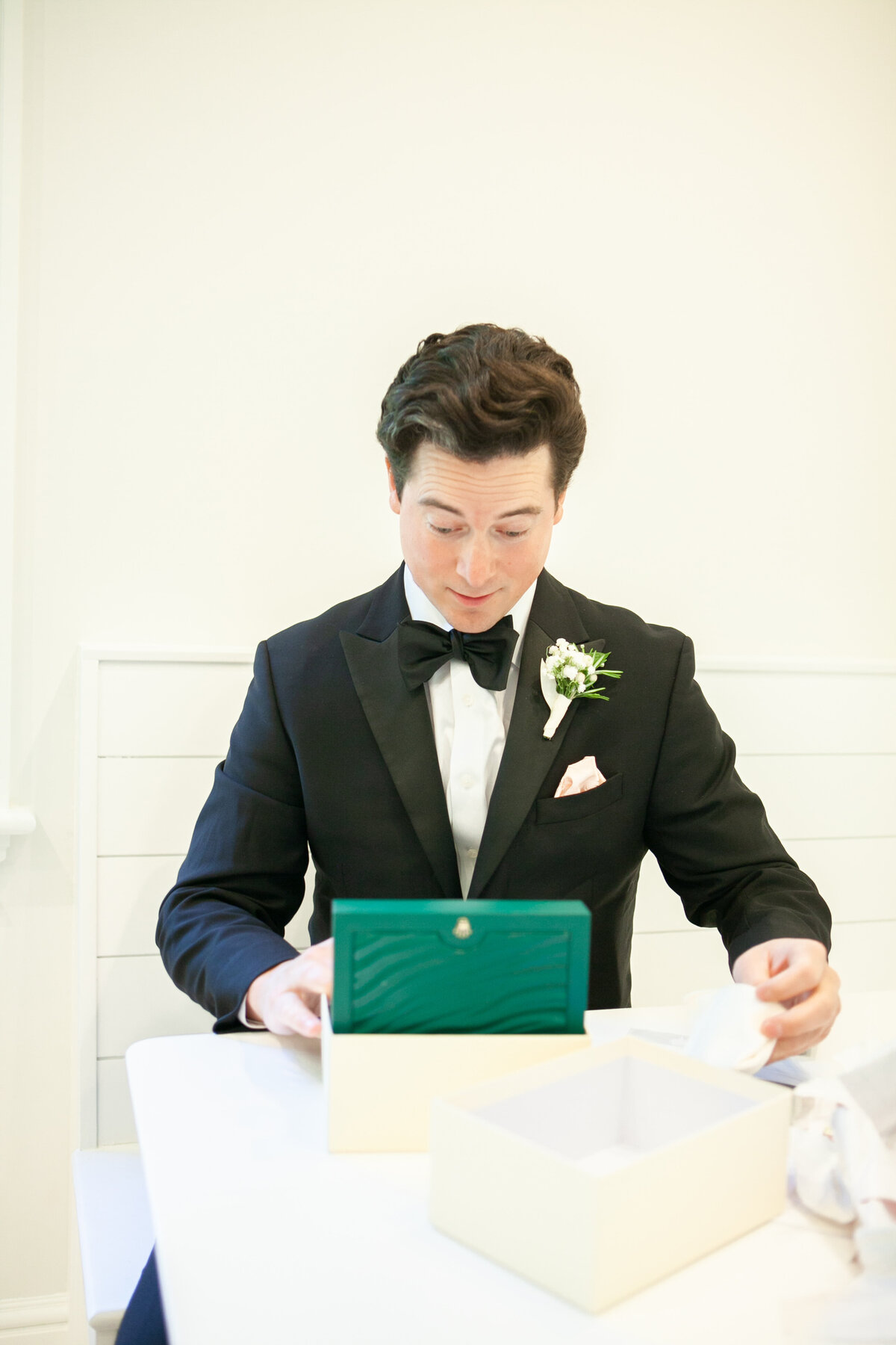 Groom reading his gift from bride