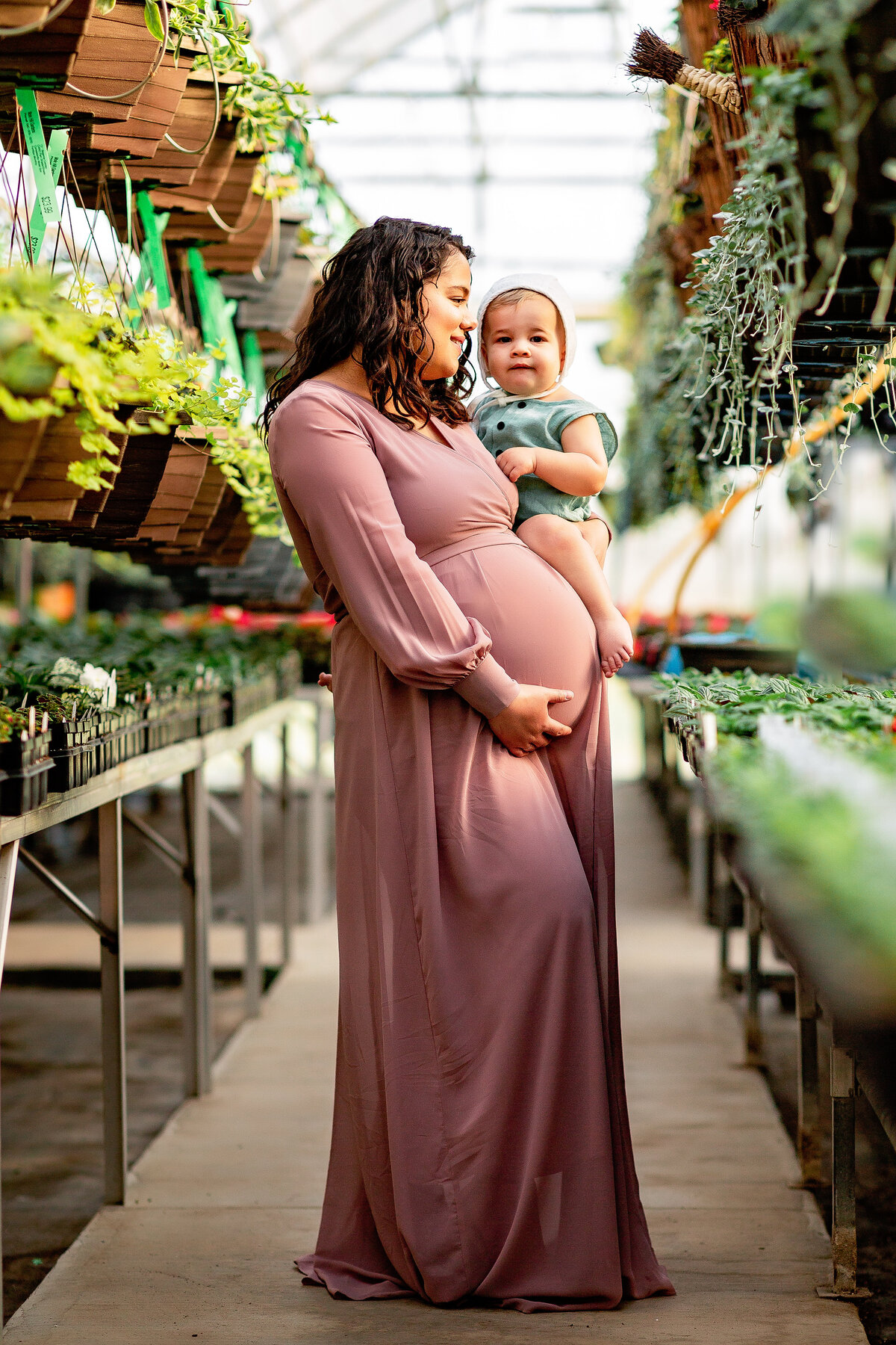 Mom and son at a greenhouse for maternity session