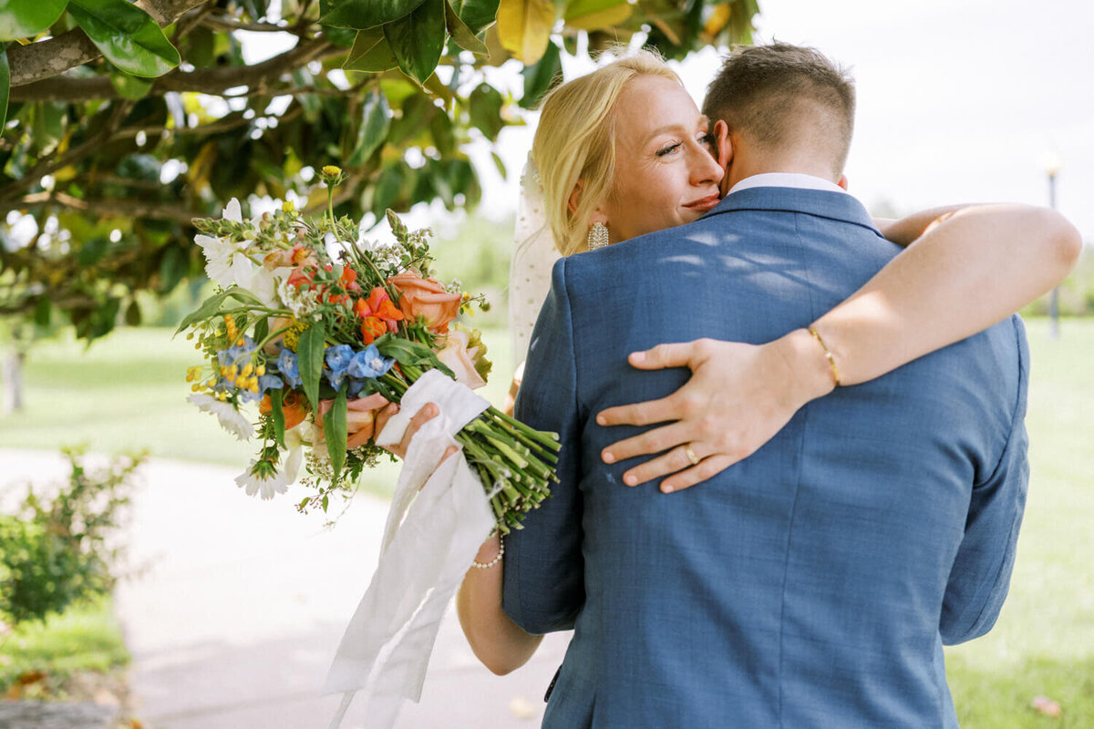 bride-with-blue-eyes-embracing-groom