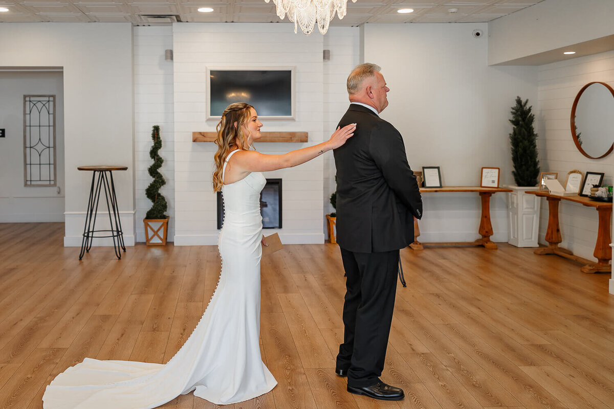 The bride and her father while he see’s her for the first time in dress during a wedding in Colorado Springs. Photo taken by Michelle Betz Photography