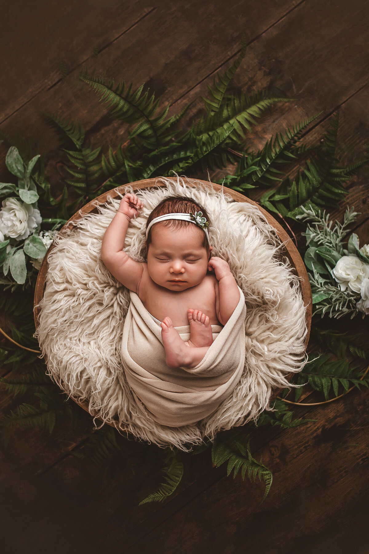 Newborn with fur and green background