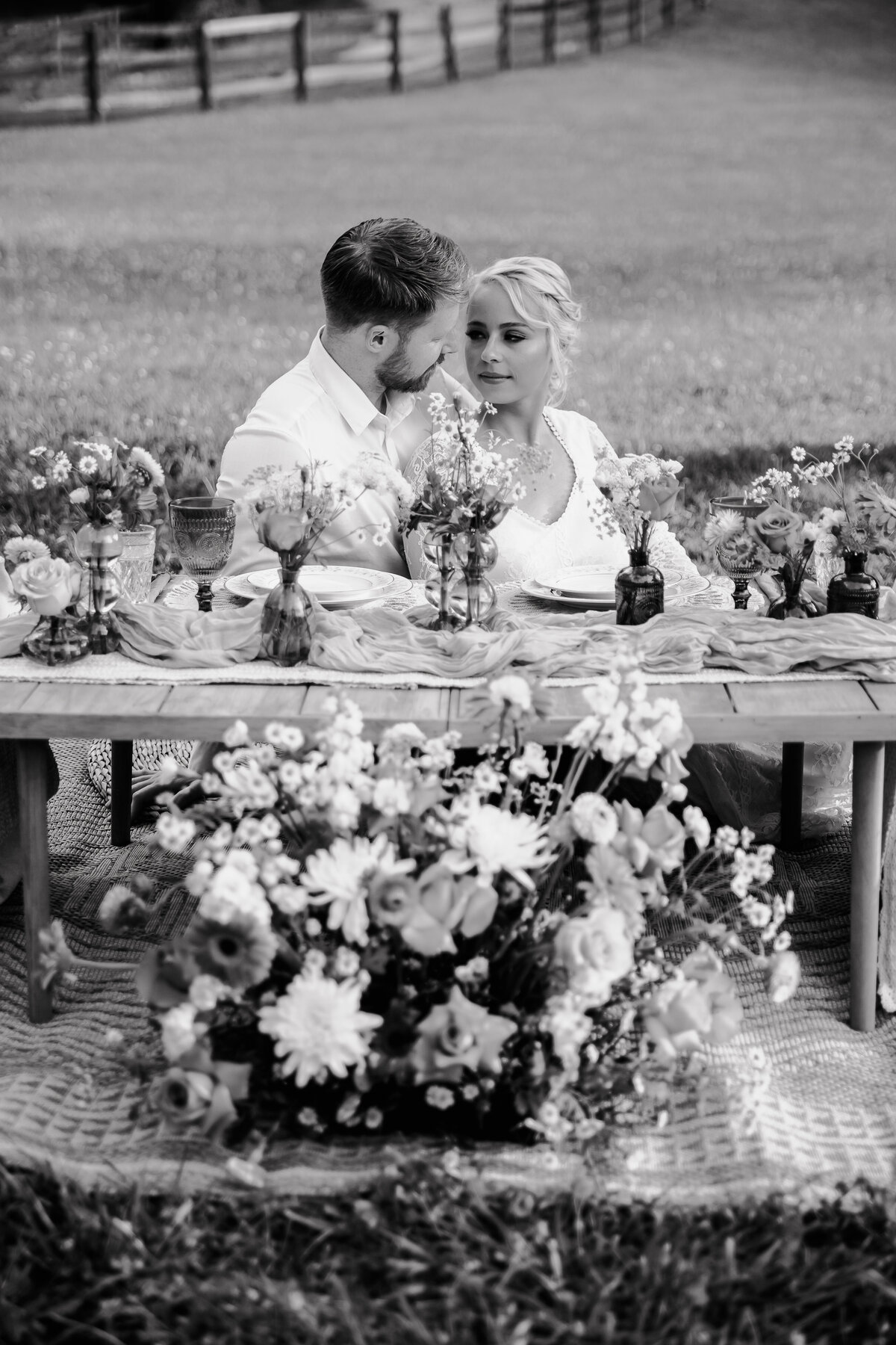 bride and groom at grazing table in black and white