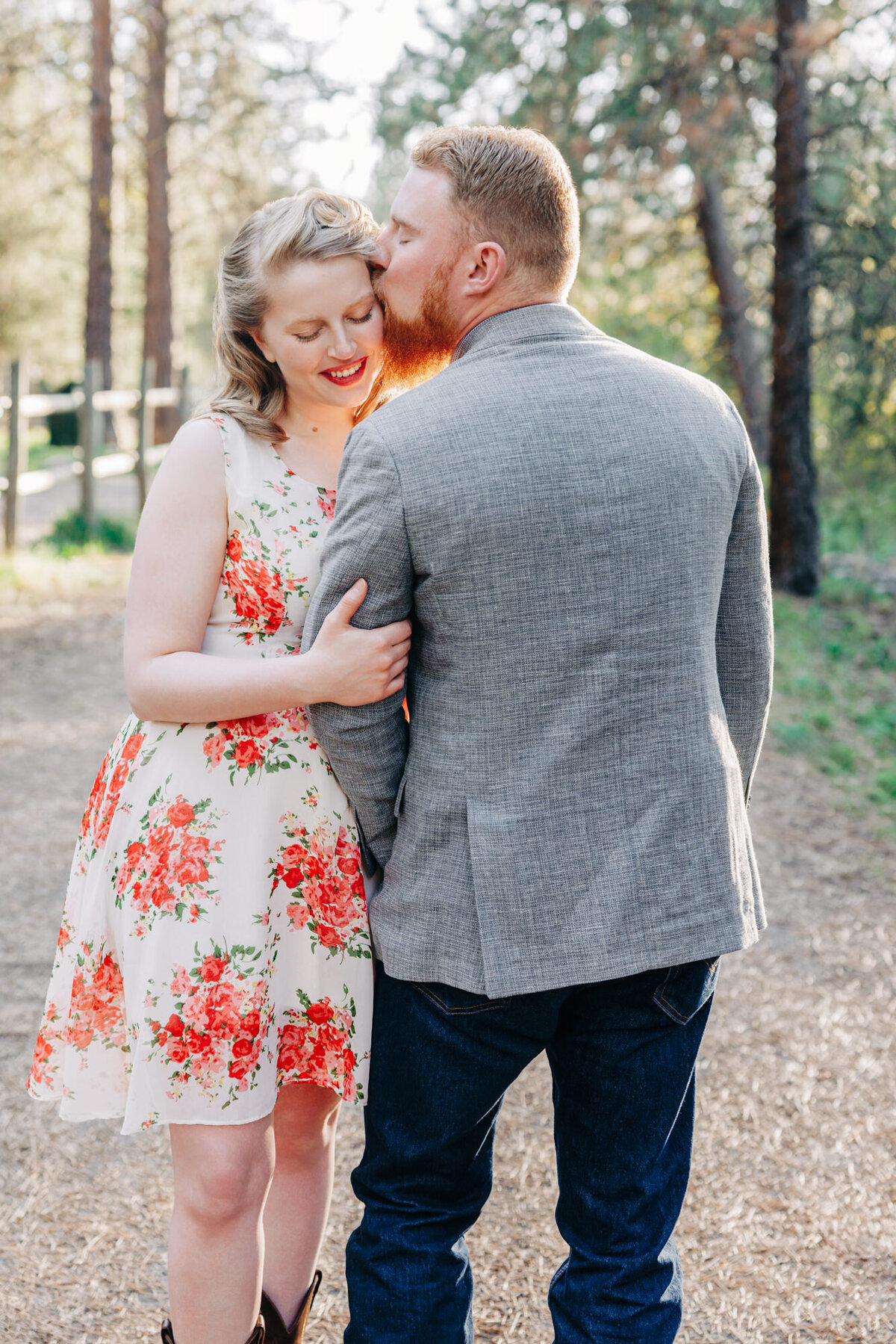 Engaged couple embracing at Lincolnwood Trailhead in Missoula, MT