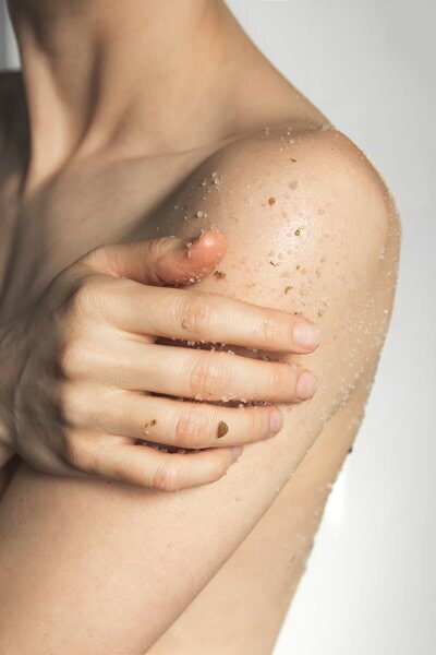 Richmond Virginia bath and beauty brand photography of natural body scrub on bare shoulder by Steph Pollard Photography.