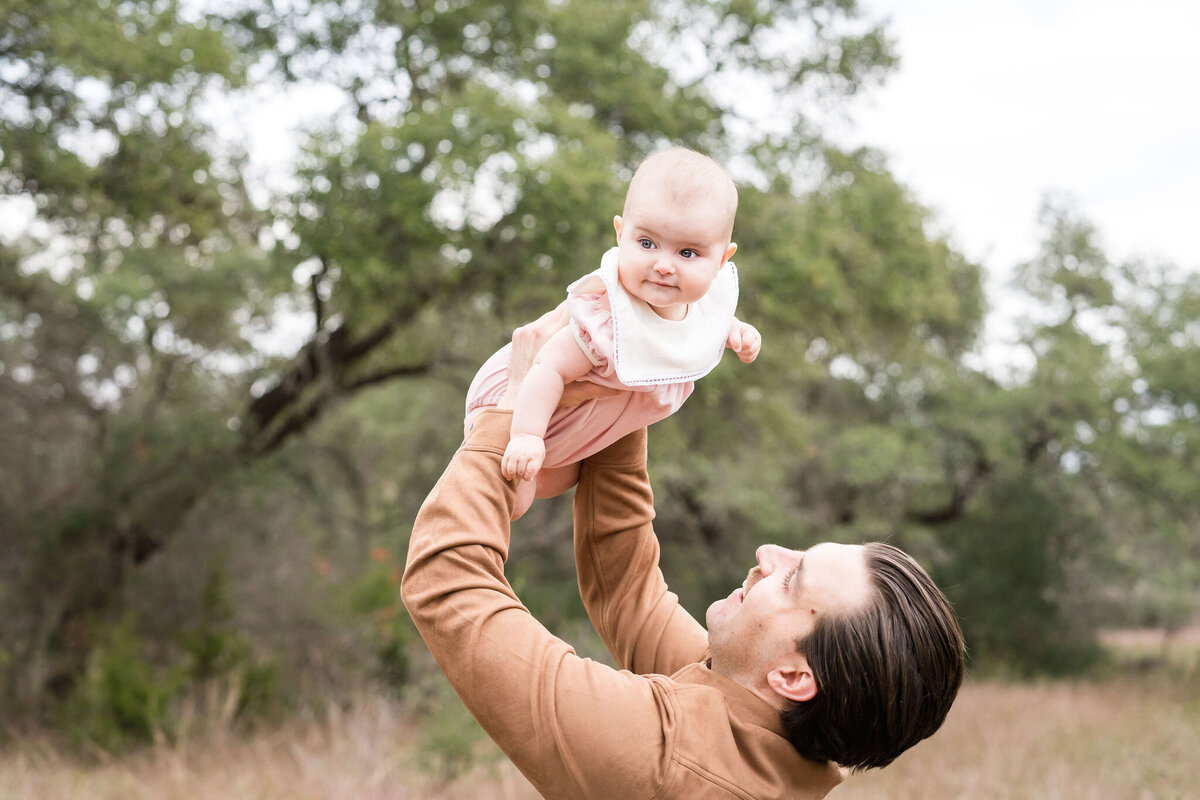 Family plays during a family photoshoot at Circle C Park in Austin, Texas.