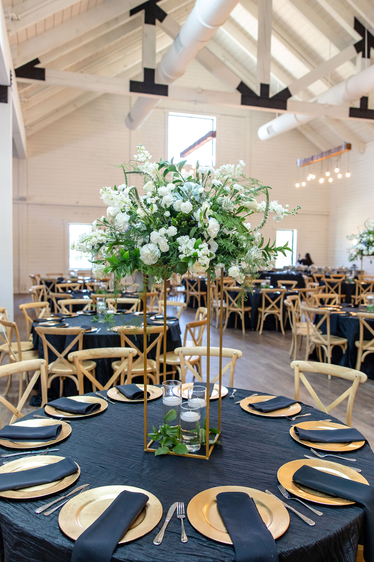 tall wedding table decor on gold stand at Morgan Creek Barn in Dripping Springs Texas