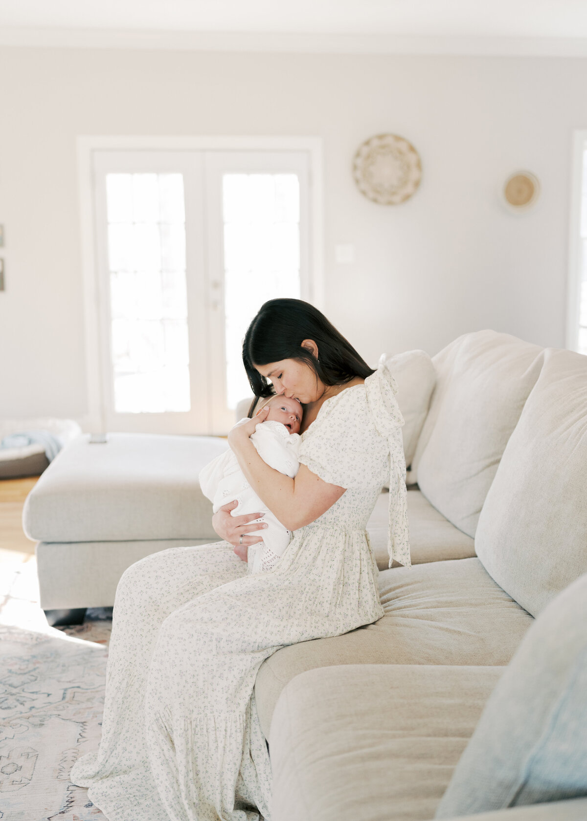 Women holding baby in arms while baby is sleeping in Virginia beach newborn session 