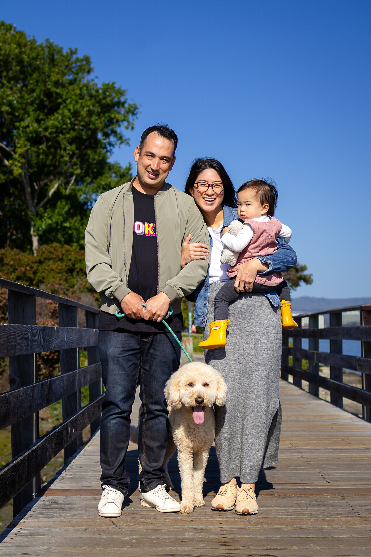 parents and girl daughter toddler bonding by the San Francisco Bay – natural light family photography by Ellobelle Photography, San Francisco Peninsula Bay Trail Burlingame