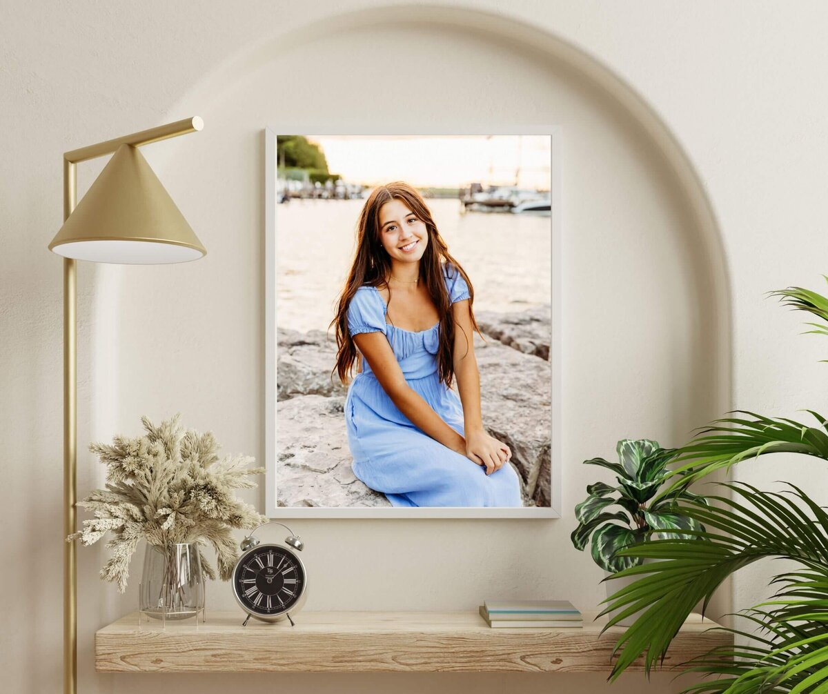 photo of a beautiful senior photo hanging on a arched wall