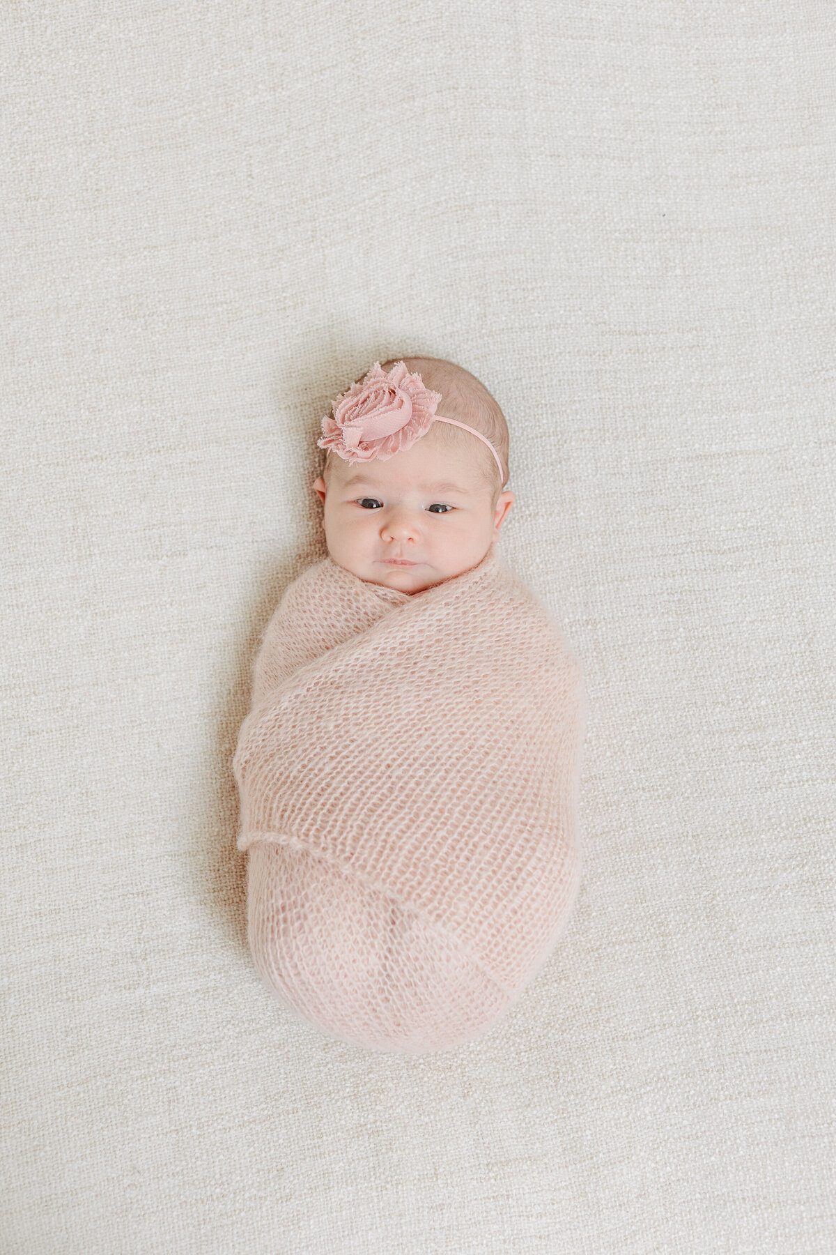 A newborn swaddled in a blanket