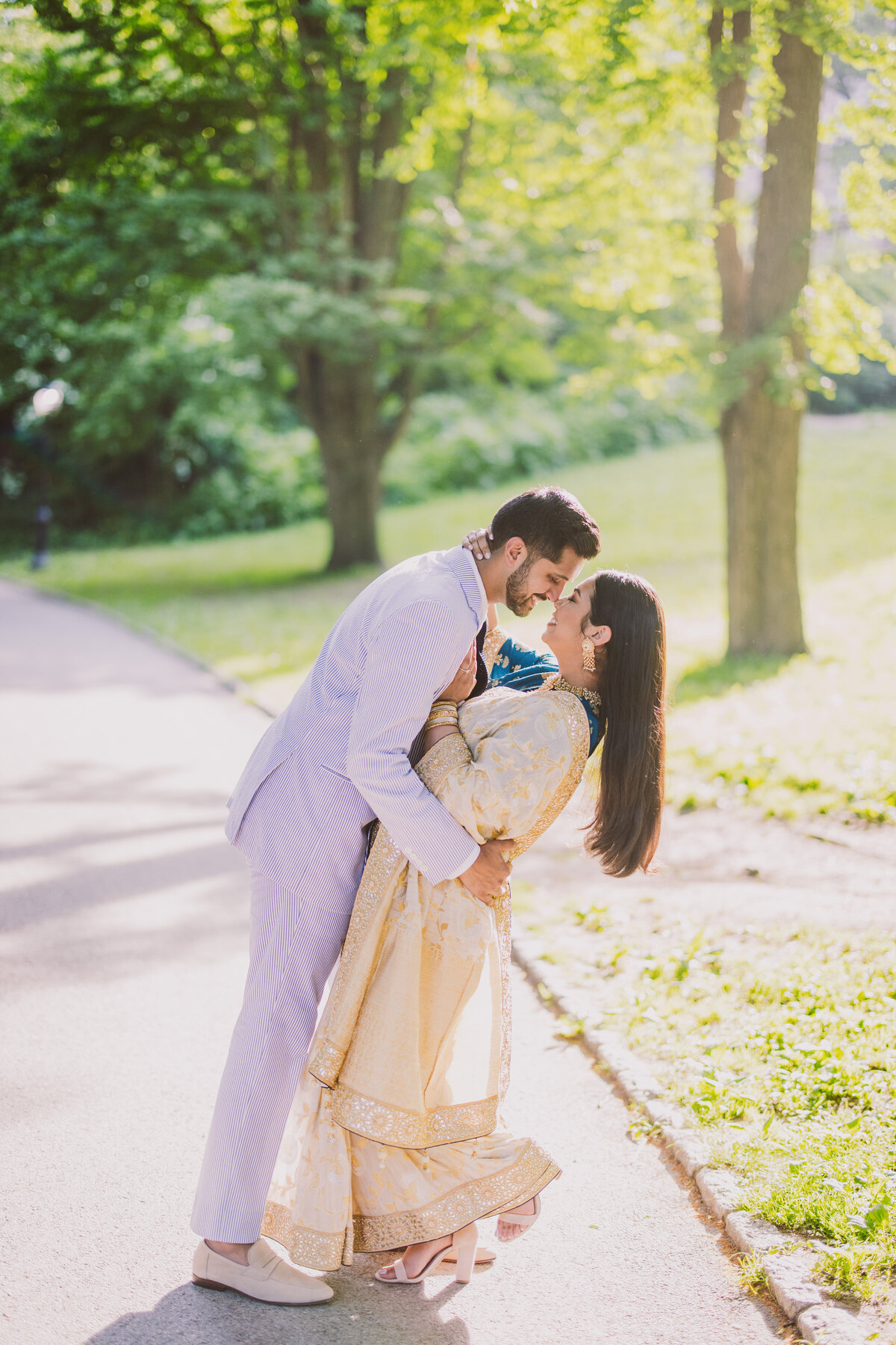 A couple sharing a moment on a walkway in central park during their engagement session