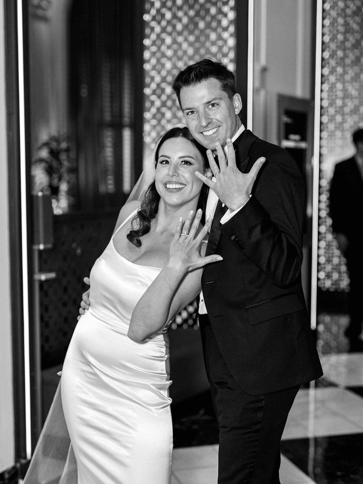 Bride and groom showing off their wedding rings