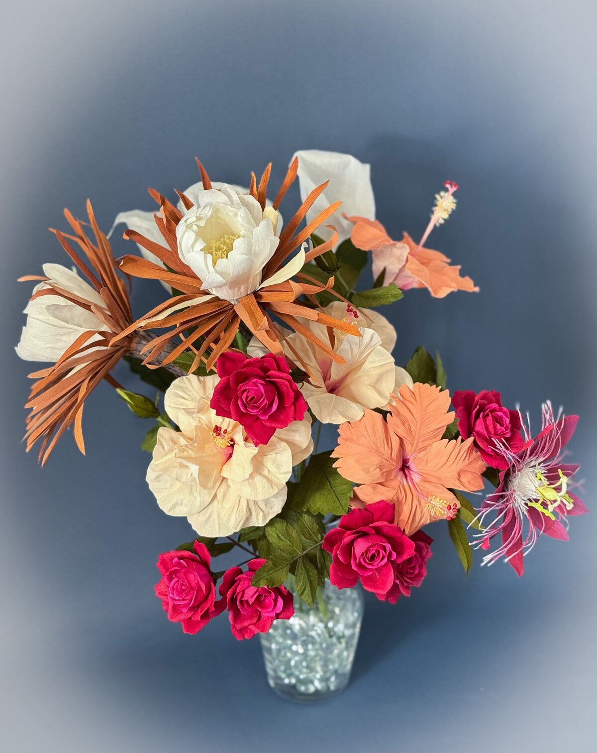Floral arrangement in apricot, white and deep pink hues