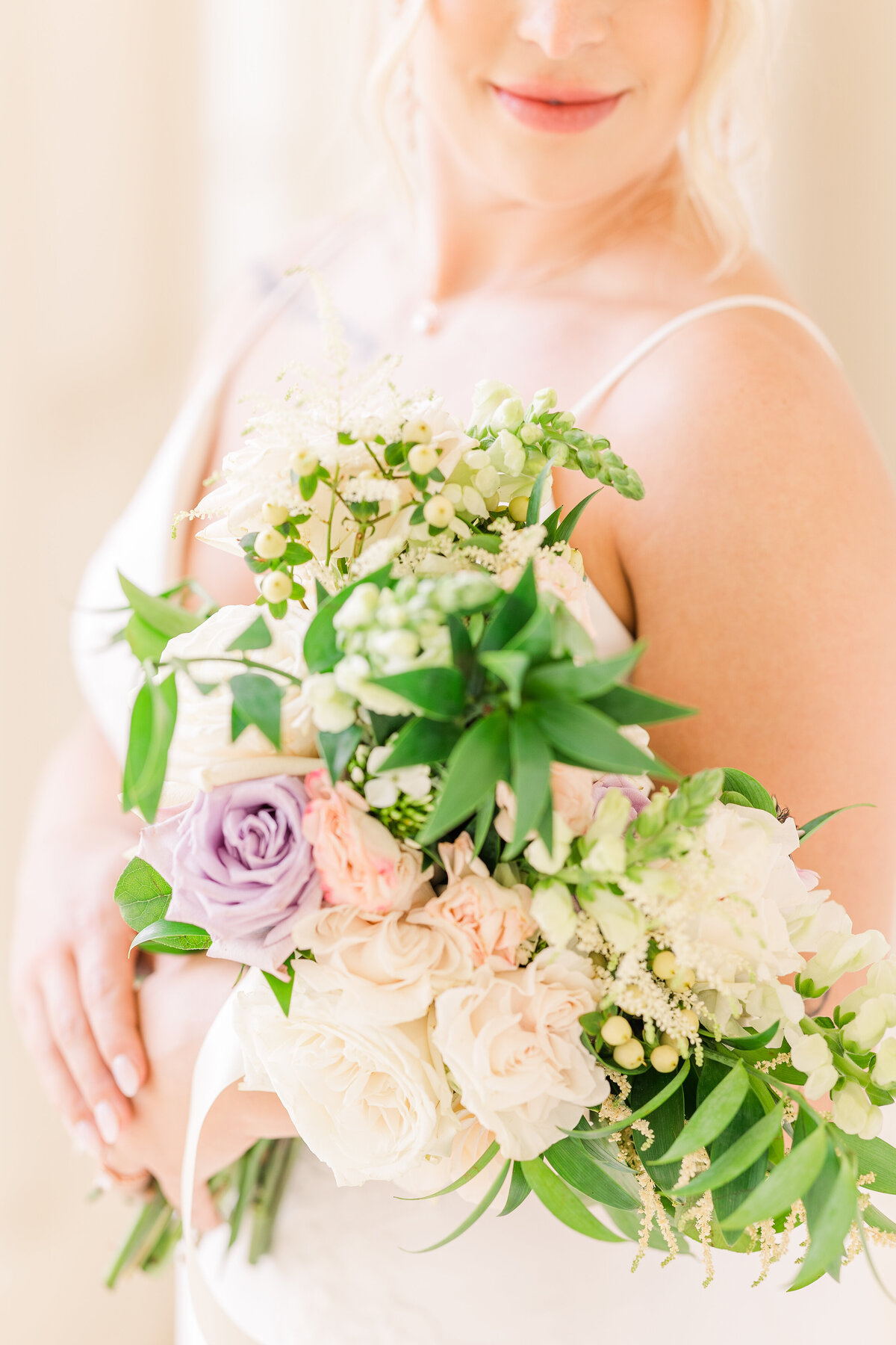 bridal-bouquet-of-ivory-blush-and-lavender-blooms-with-greenery