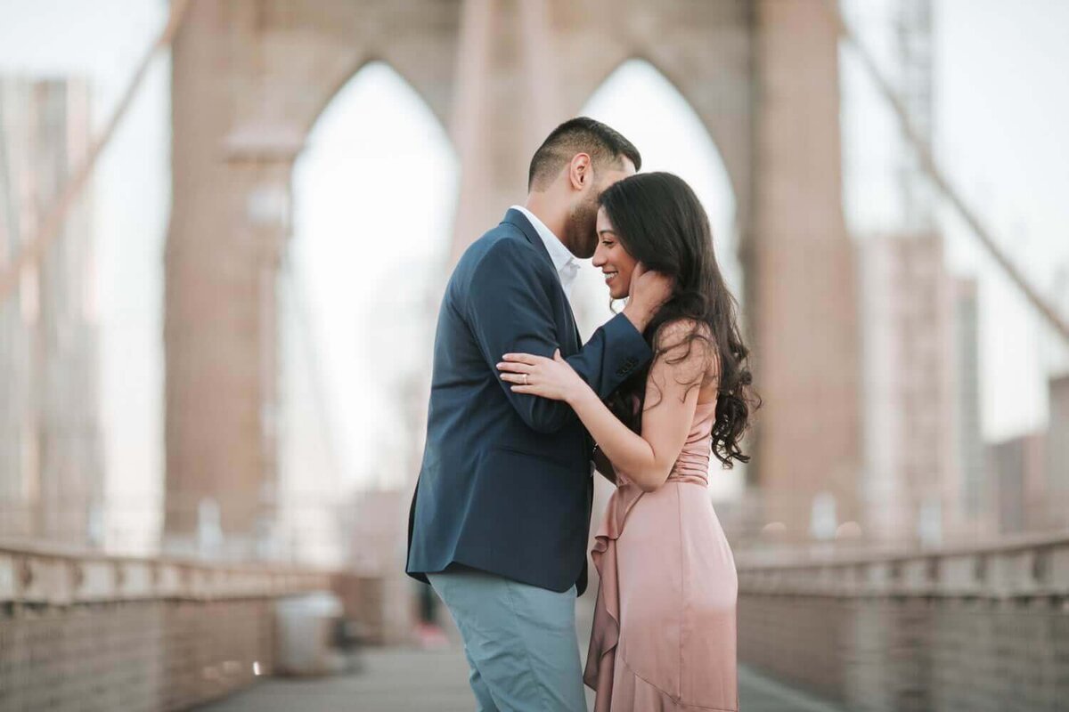 Couple kissing on bridge in Philadelphia.