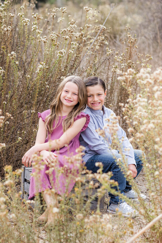 children-sitting-in-golden-field-sweetwater-river-bridge-san-diego
