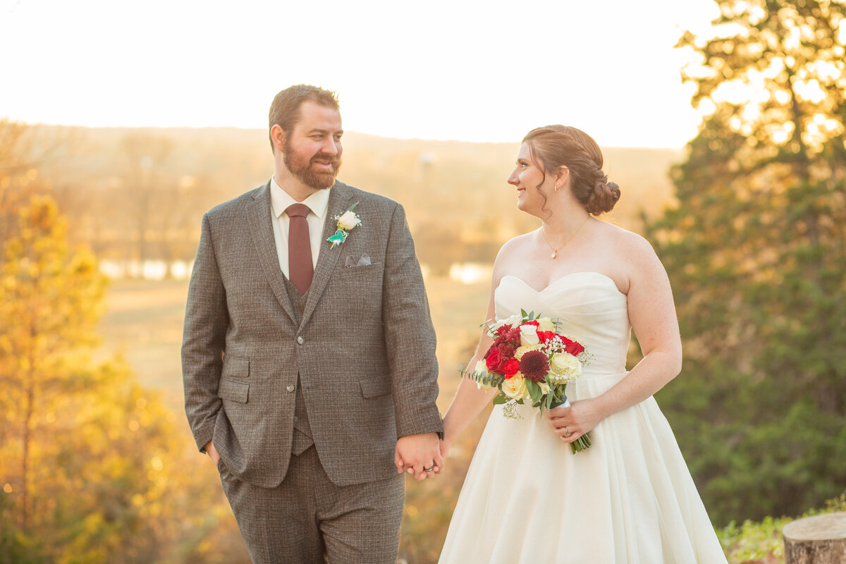 The bride is holding her wedding bouquet while smiling and looking at the groom. This wedding was at Historic Tuckahoe in Richmond, Virginia.