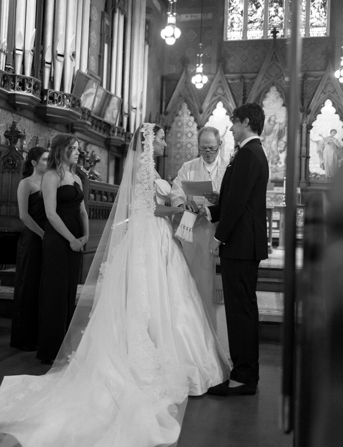 A bride and groom exchange vows among ornate detail at Detroit's historic Christ Church