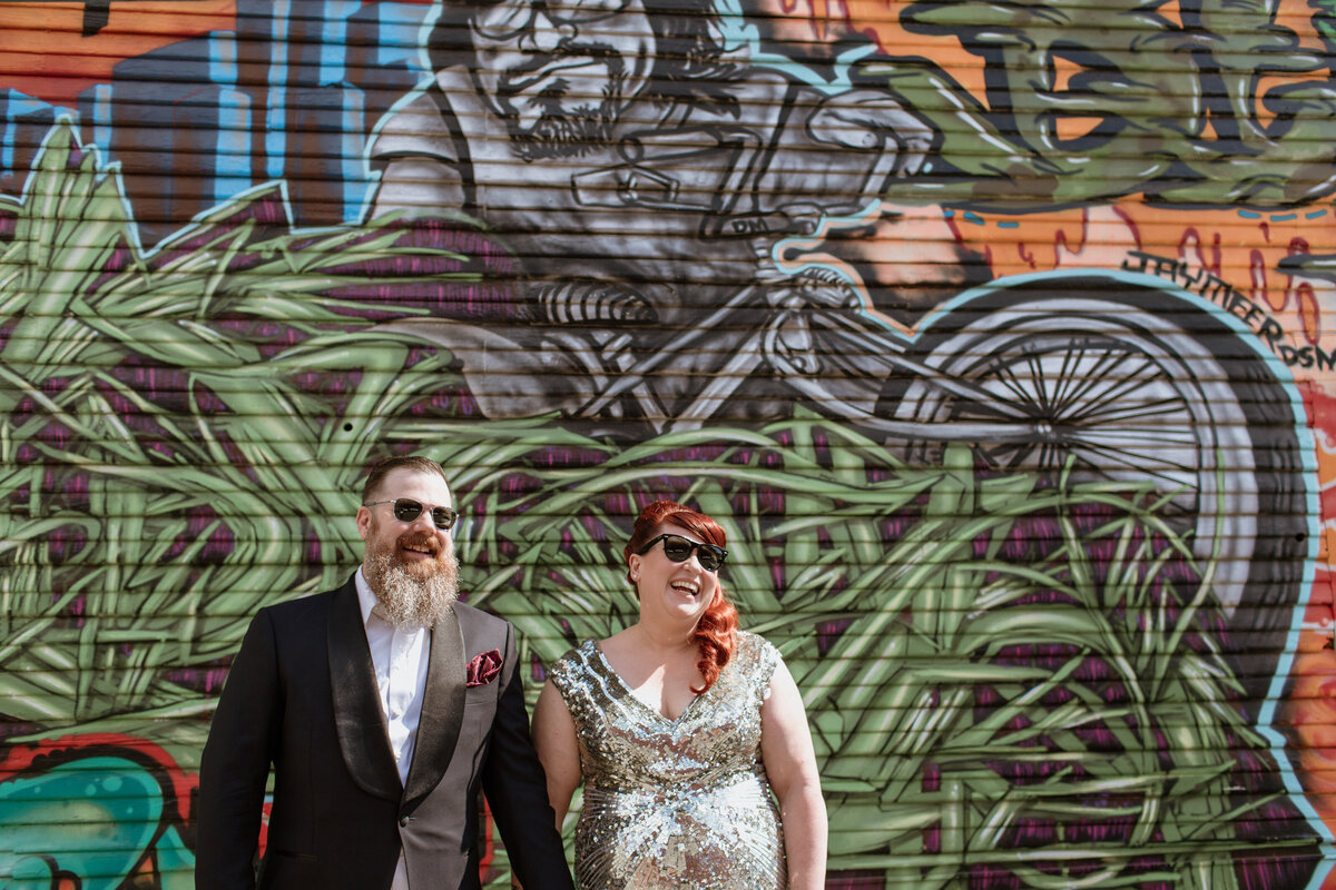 Fort Worth Wedding Photographer Megan Christine Studio captures a cool alternative couple against colorful graffiti art. 