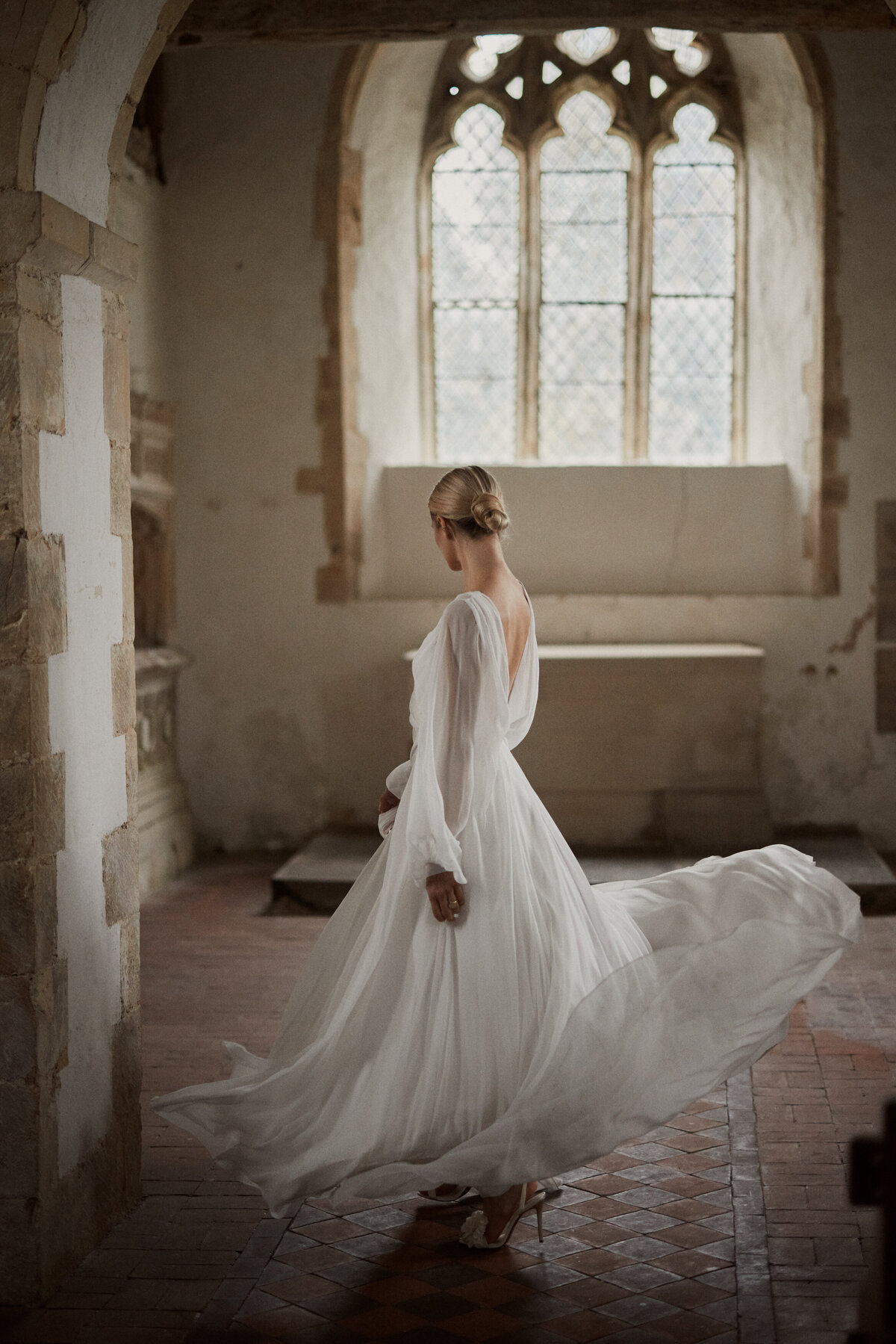 Flowing wedding dress in silk by British designer