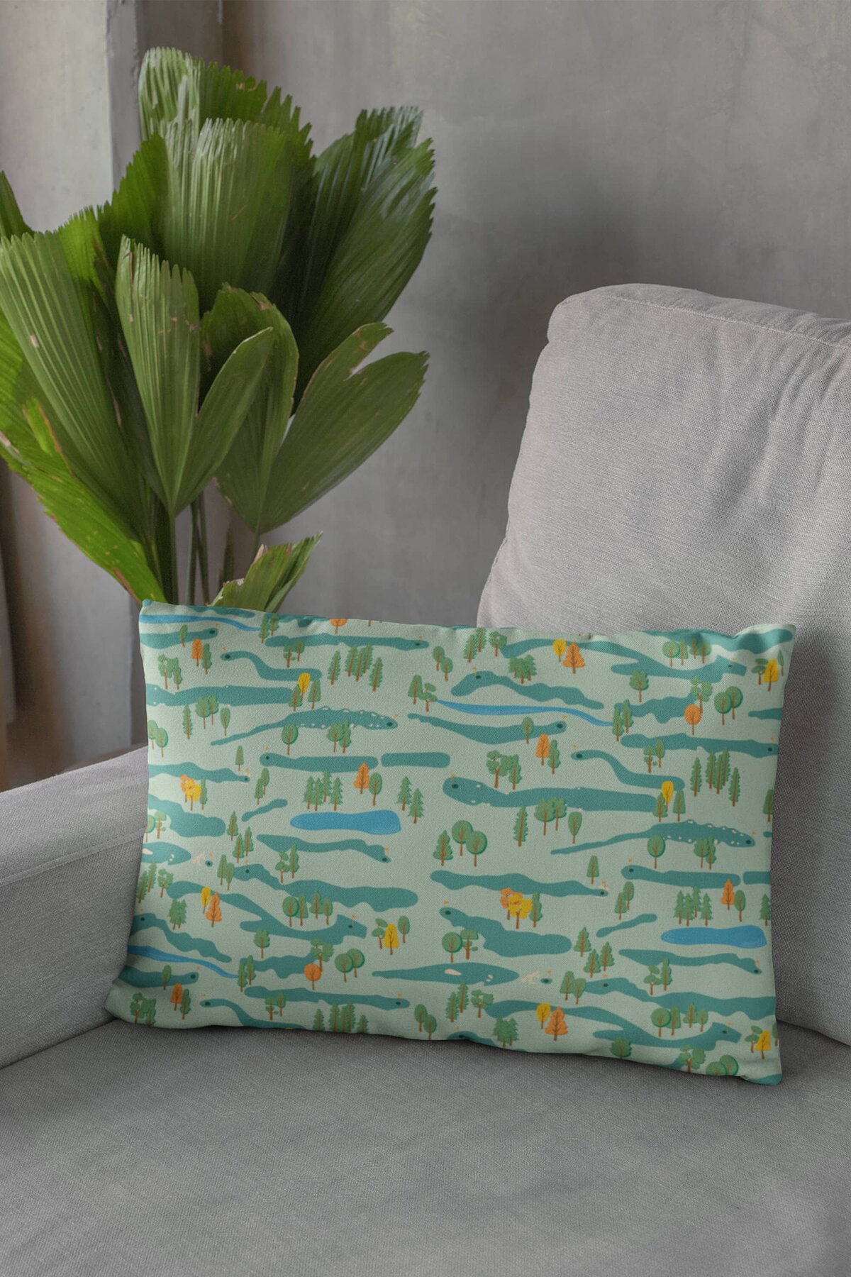 A throw pillow printed with The Indoor Golf Lounge brand pattern sitting in the corner of a gray couch