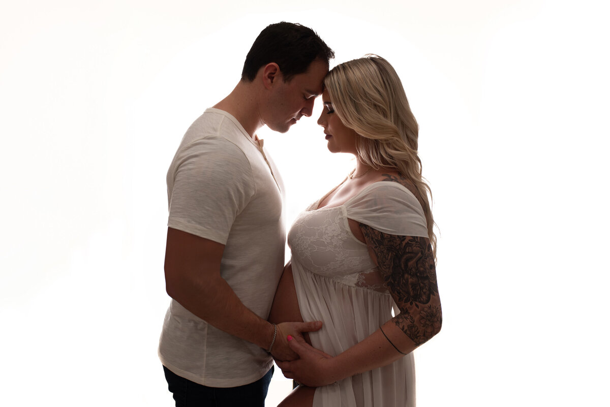 Atlanta, Georgia newborn photographer portrait session with pregnant woman at maternity session silhouette pose with husband and pregnant wife