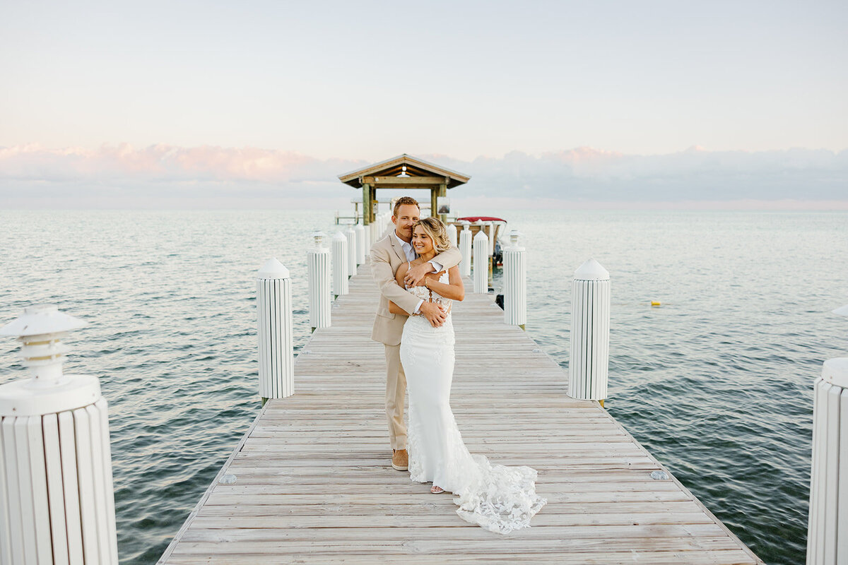 Hunter gently embraces Ashley as they take in the sunset views from the dock.