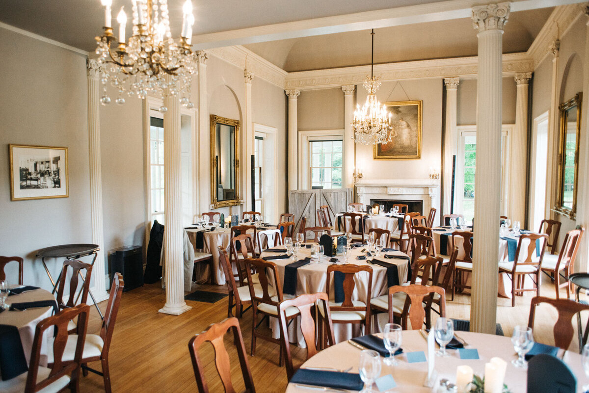 Elegant indoor set up of tables for a wedding reception