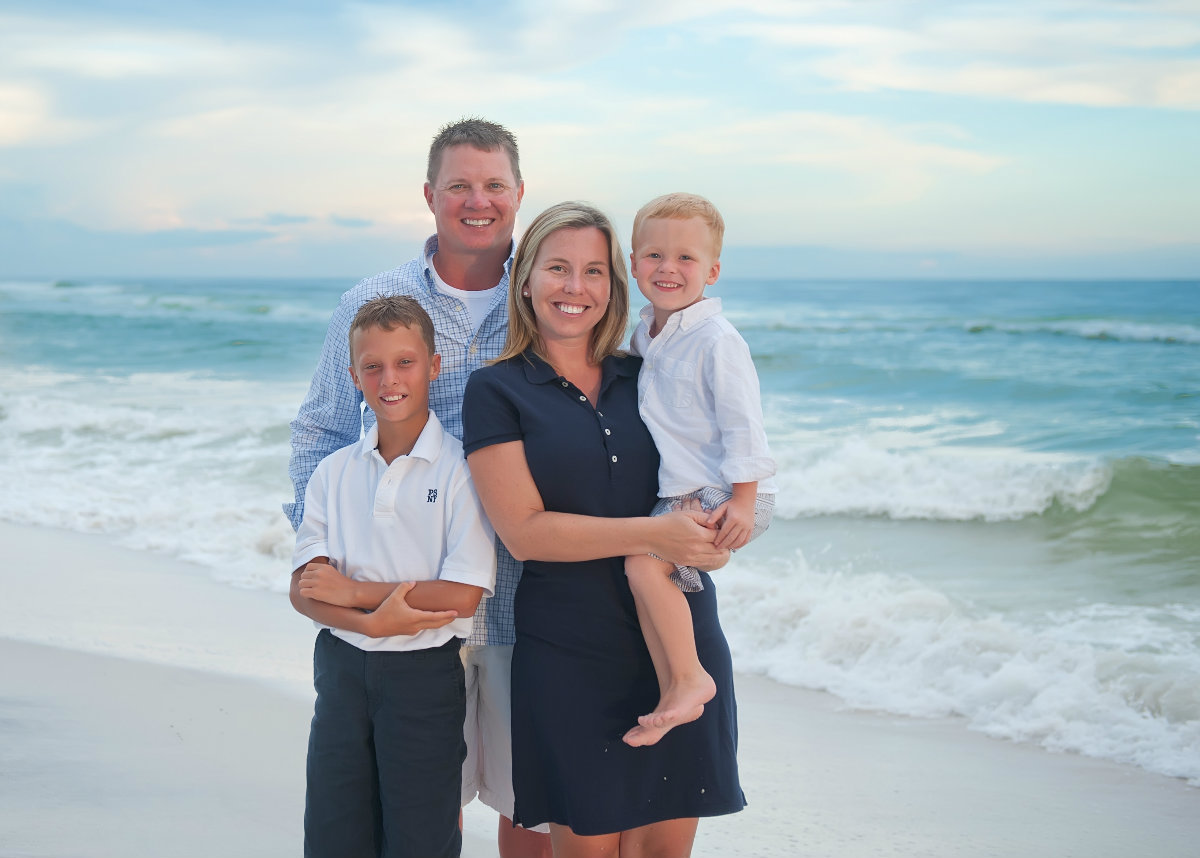 Family with two boys standing on the beach in Watersound 30a
