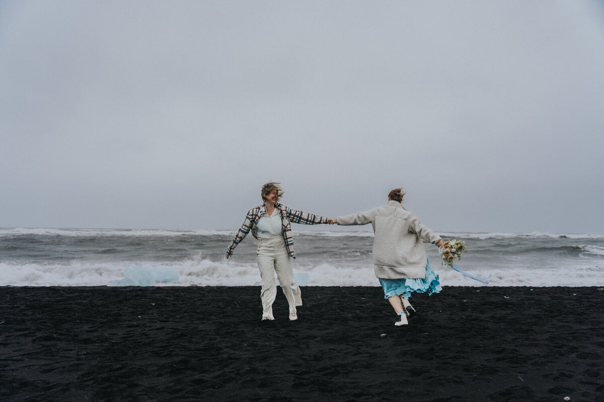 Brides spin each other during their LGBTQ Iceland elopement 