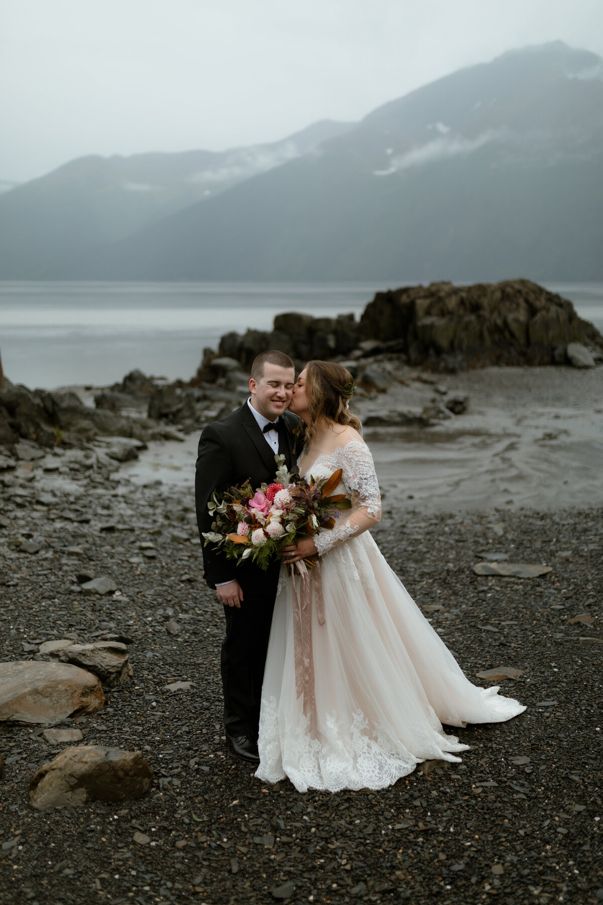 Bride kissing grooms cheek