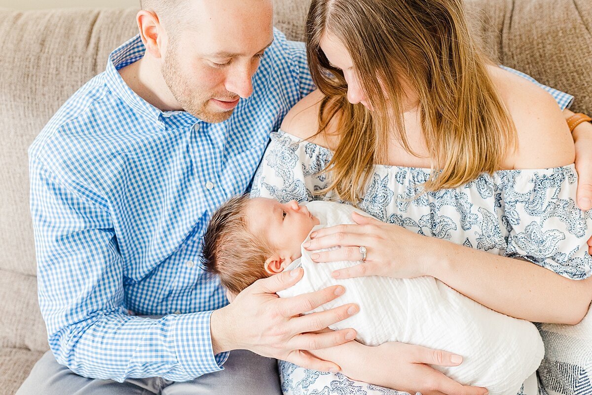 parents hold baby during in home newborn photo session with Sara Sniderman Photography  i Natick Massachusetts