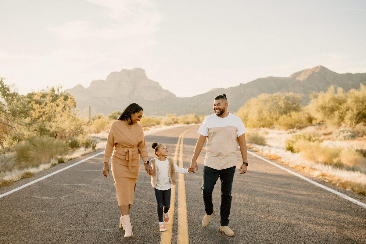 parents walk with daughter down arizona road