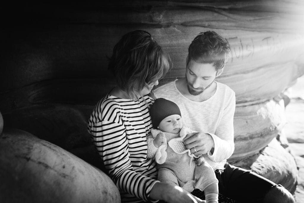 Parents relaxing with their baby during a beach outing at Maroubra Beach– candid Sydney family photography