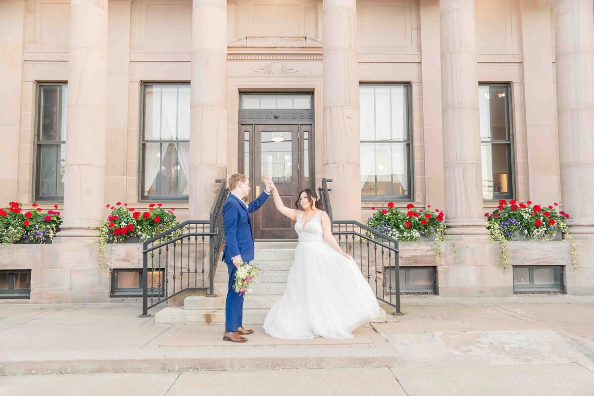 Bride and Groom dancing in front the the Historical Post Office in Ottawa Kansas