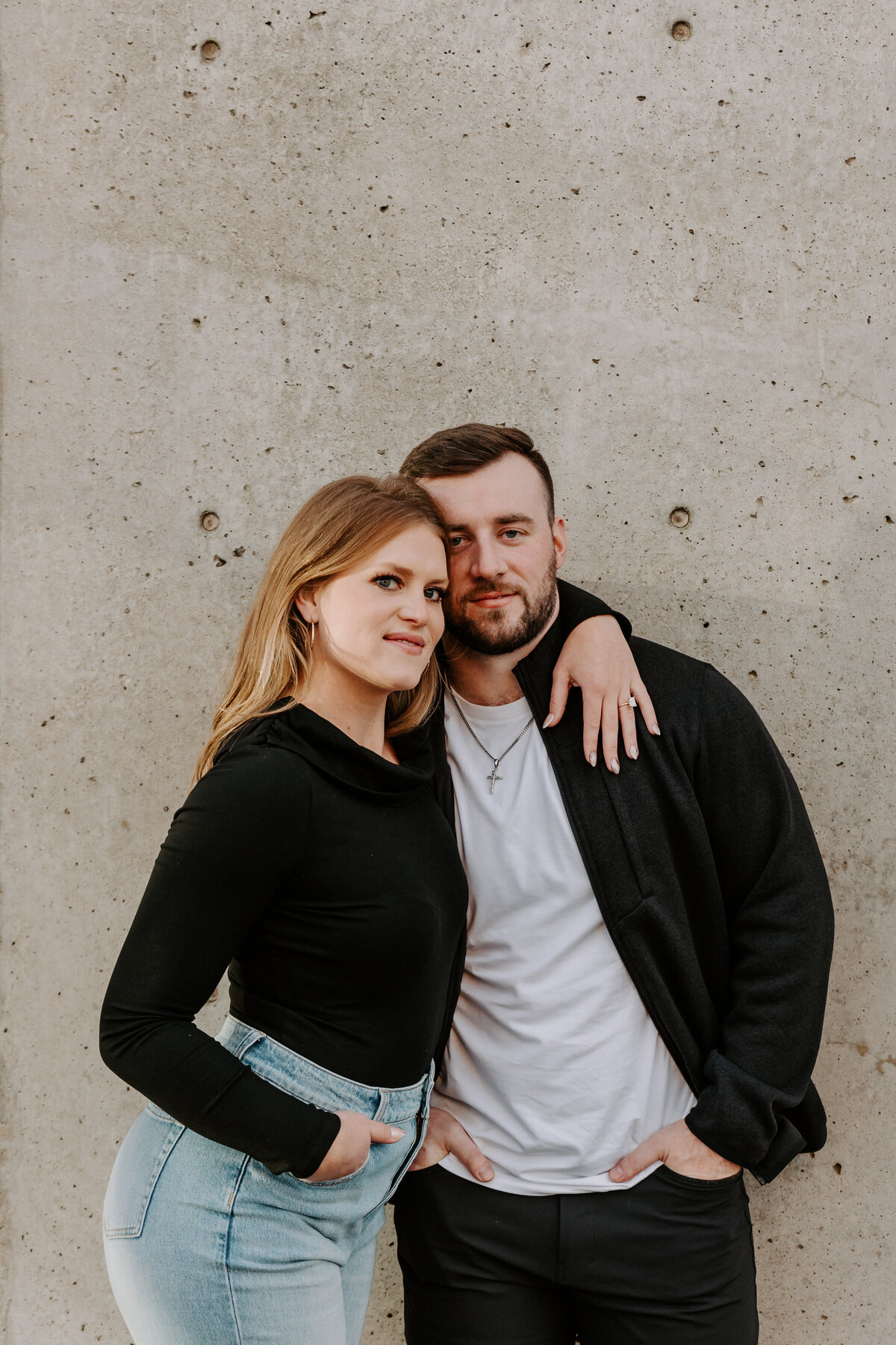 A couple with their arms around each other smiling