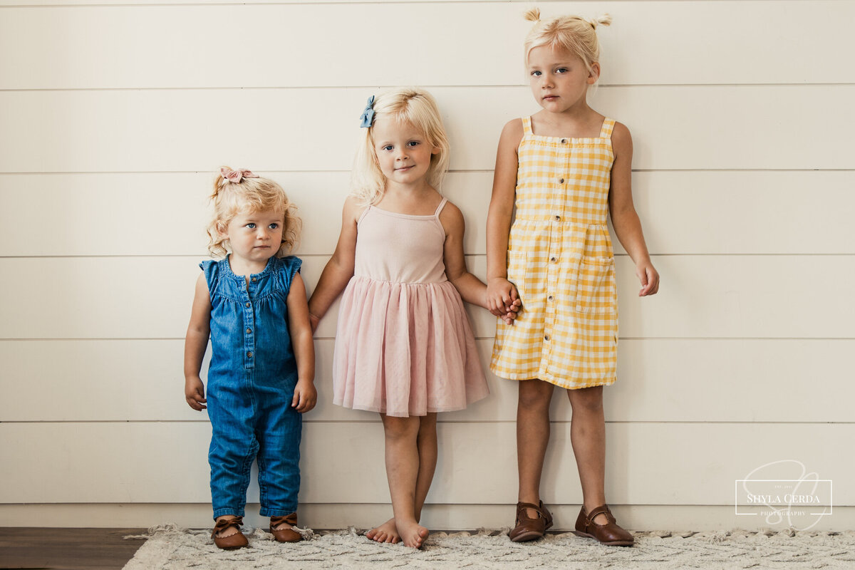 Three sisters holding hands