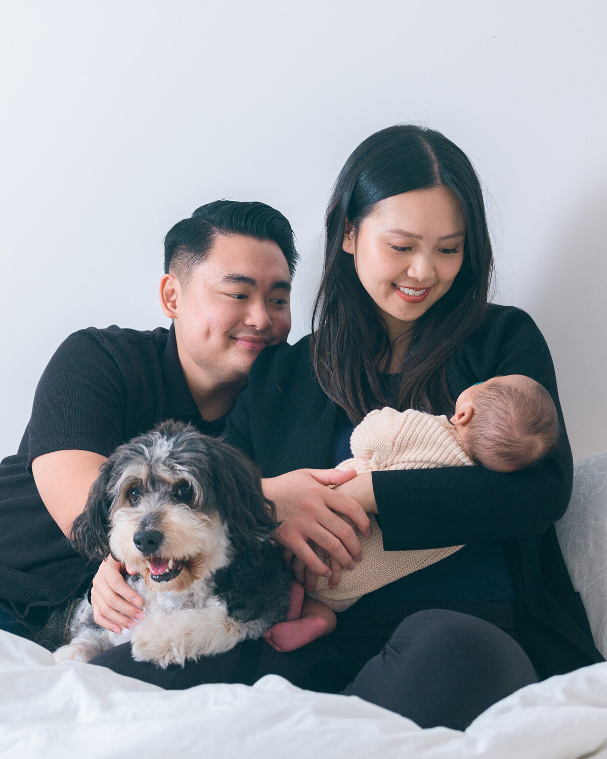 Happy family with a newborn baby and pet dog, beautifully photographed by the best newborn photographer in Los Altos