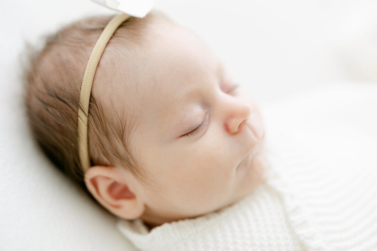 close up of a newborn's face while sleeping