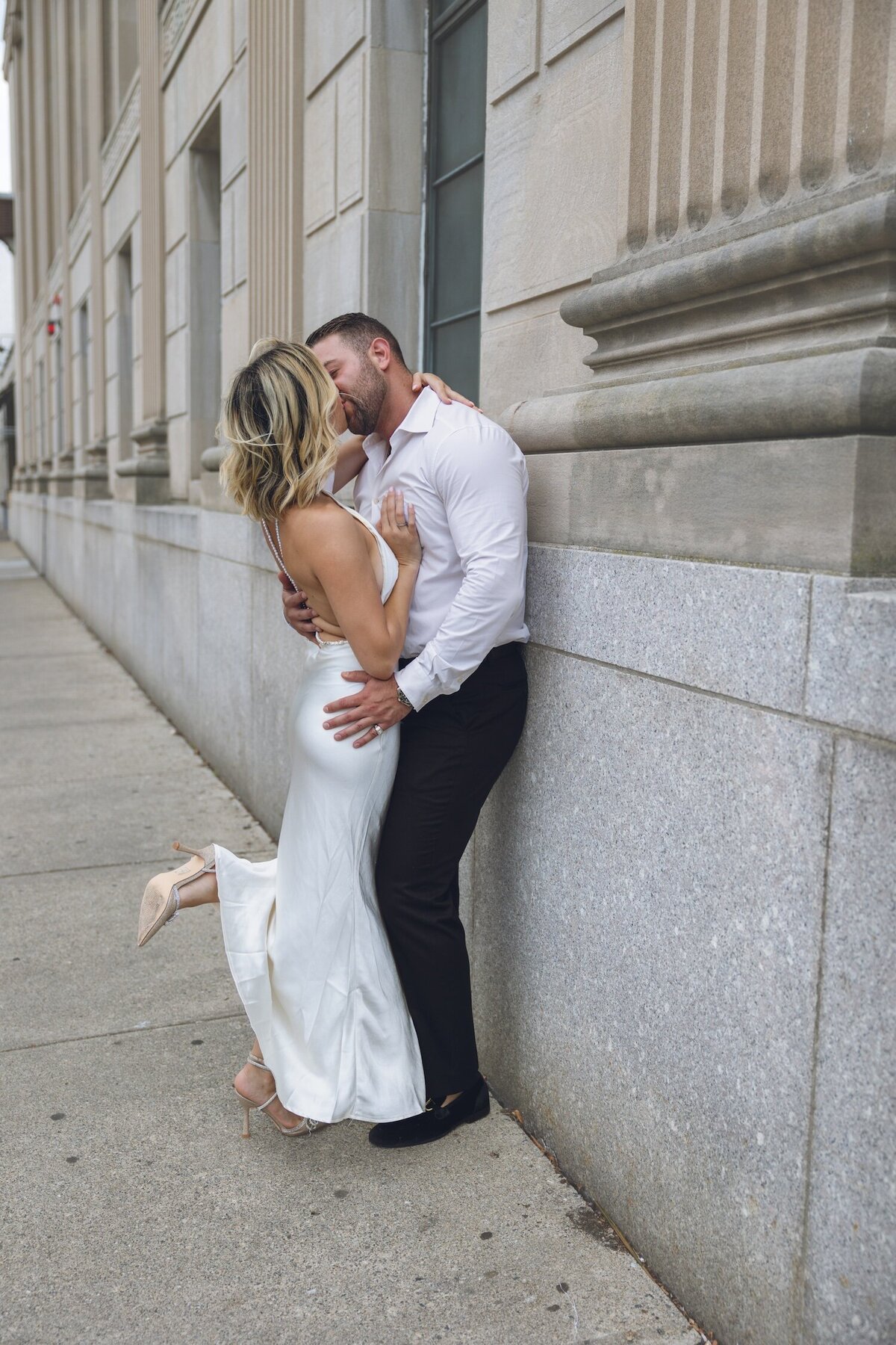 Couple embracing and smiling outside of Felina’s stone exterior.