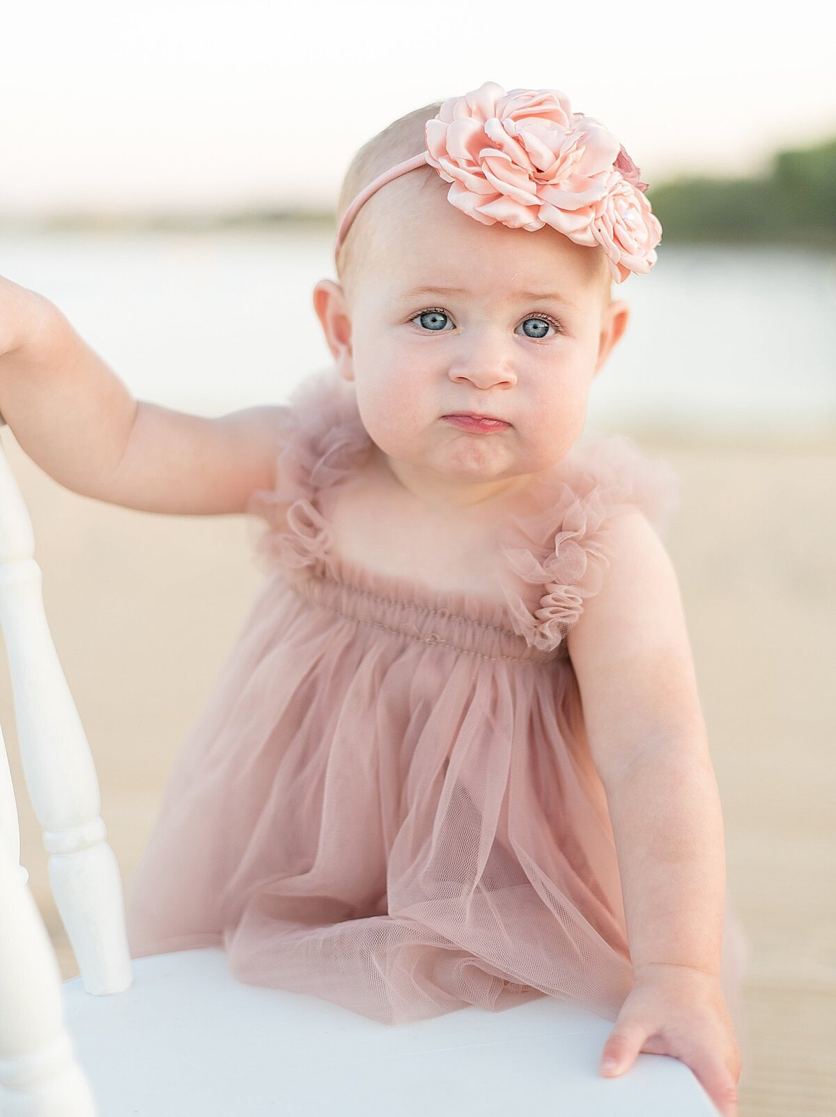 little girl holding onto chair