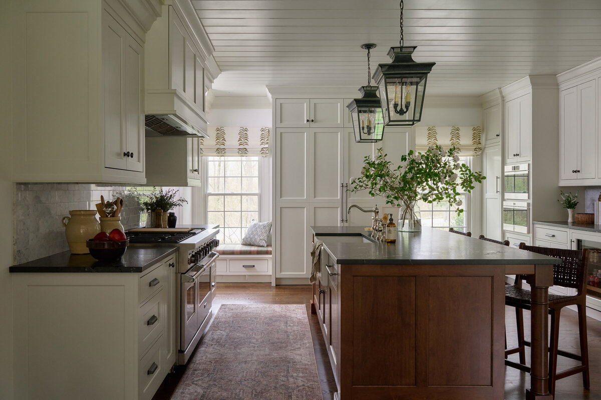 Kitchen at the Dunham House with creamy cabinets and a wooden island