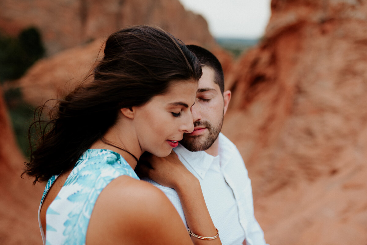 Moab Utah photo of couple for engagement photo shoot with Arches National Park in background