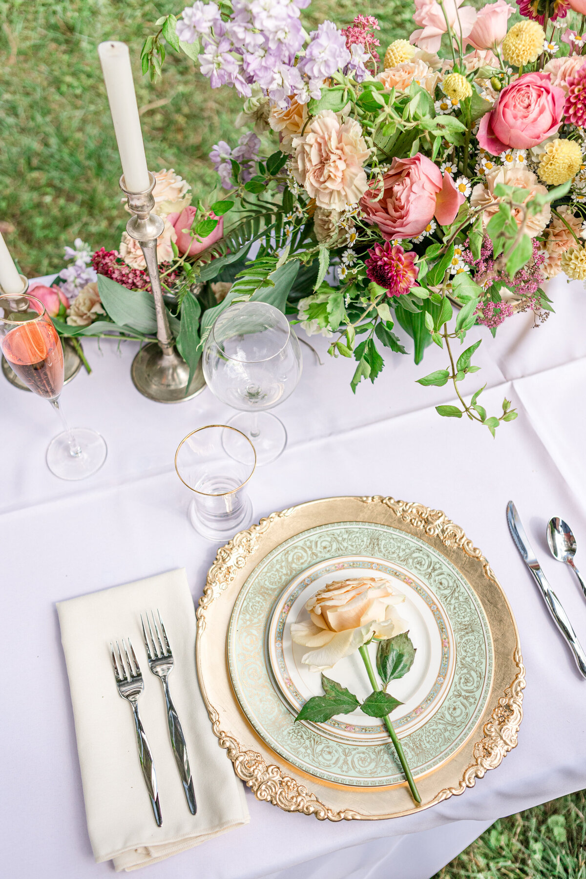 Detail photo of a place setting and florals for a wedding reception in West Jefferson, NC